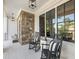 Inviting front porch with stone accents, rocking chairs, and black frame windows at 1963 Skybrooke Ln, Hoschton, GA 30548