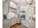 Kitchen with granite countertops, grey cabinets, hardwood floors, and stainless steel built-in microwave and oven at 1963 Skybrooke Ln, Hoschton, GA 30548