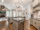 Spacious kitchen with hardwood floors, granite countertops, double islands, and stainless steel appliances at 1963 Skybrooke Ln, Hoschton, GA 30548