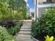 Backyard garden path with beautiful landscaping and flowering shrubbery at 1963 Skybrooke Ln, Hoschton, GA 30548