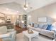 Living room with hardwood floors, bright windows, an adjacent open kitchen, and white sofa at 1963 Skybrooke Ln, Hoschton, GA 30548