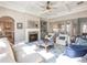 Bright living room with a fireplace, coffered ceiling, and views into other rooms at 1963 Skybrooke Ln, Hoschton, GA 30548