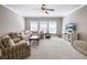 Spacious living room with a comfortable sectional sofa, TV, and plenty of natural light at 1963 Skybrooke Ln, Hoschton, GA 30548
