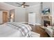 Inviting primary bedroom with a cozy fireplace, hardwood flooring, and stylish decor offers a relaxing retreat at 1963 Skybrooke Ln, Hoschton, GA 30548