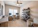 Office with natural light, desk setup, shelving unit, and comfortable seating area at 1963 Skybrooke Ln, Hoschton, GA 30548