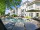 Stunning backyard with a large pool, stone patio, and outdoor seating area perfect for relaxing at 1963 Skybrooke Ln, Hoschton, GA 30548