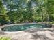 Sparkling pool with a stone waterfall feature and an outdoor fireplace perfect for relaxing and entertaining at 1963 Skybrooke Ln, Hoschton, GA 30548