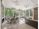 Screened-in porch with comfortable seating, dining table, and ceiling fans, perfect for outdoor living at 1963 Skybrooke Ln, Hoschton, GA 30548