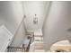 Spacious entryway showing staircase with wooden banister and metal spindles, and cathedral ceiling at 1963 Skybrooke Ln, Hoschton, GA 30548