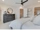 Bedroom featuring white bedding, ceiling fan, and view into bathroom at 4822 Floydwood Ln, Mableton, GA 30126