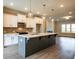 Open-concept kitchen with a large island, pendant lighting, and modern appliances perfect for entertaining at 4822 Floydwood Ln, Mableton, GA 30126