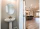 Convenient powder room with a modern pedestal sink, located adjacent to the kitchen and living area at 4822 Floydwood Ln, Mableton, GA 30126