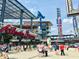 Exterior view of Truist Park, home of the Atlanta Braves, bustling with fans and activity at 4822 Floydwood Ln, Mableton, GA 30126