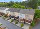 Aerial view of townhomes featuring well-kept decks, attractive landscaping, and neighborhood street at 4879 Seldon Se Way, Smyrna, GA 30080