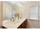 Bathroom featuring double sinks with wooden cabinets and natural light at 4879 Seldon Se Way, Smyrna, GA 30080