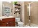 Cozy bathroom with tiled shower, wood vanity, and industrial-style shelving at 4879 Seldon Se Way, Smyrna, GA 30080