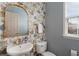 Bathroom with floral wallpaper, window, toilet and sink at 4879 Seldon Se Way, Smyrna, GA 30080