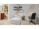 Comfortable room with a sitting chair, desk and stylish wall shelves in neutral tones at 4879 Seldon Se Way, Smyrna, GA 30080