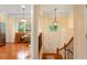 View of the entryway with hardwood floors, a staircase, and views into the adjacent living room and kitchen at 4879 Seldon Se Way, Smyrna, GA 30080