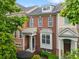 Charming townhome with brick facade, covered porch, and manicured landscaping, creating an inviting curb appeal at 4879 Seldon Se Way, Smyrna, GA 30080