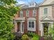 Charming townhome with brick facade, covered porch, and manicured landscaping, creating an inviting curb appeal at 4879 Seldon Se Way, Smyrna, GA 30080