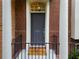 Close-up of the front door with a black railing and welcome mat, offering a warm and inviting entrance at 4879 Seldon Se Way, Smyrna, GA 30080