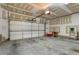 Spacious garage with a clean concrete floor, white door, and ample storage space at 4879 Seldon Se Way, Smyrna, GA 30080