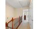 Hallway with wooden railing and view into bedroom at 4879 Seldon Se Way, Smyrna, GA 30080