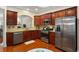 A kitchen featuring granite countertops, stainless steel appliances, and wooden cabinets and hardwood floors at 4879 Seldon Se Way, Smyrna, GA 30080