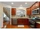 A kitchen featuring granite countertops, stainless steel appliances, and wooden cabinets with view into an adjacent room at 4879 Seldon Se Way, Smyrna, GA 30080