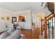 A living room featuring a fireplace, hardwood floors, and furniture, with view into kitchen and entry at 4879 Seldon Se Way, Smyrna, GA 30080