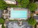 Aerial view of a community pool surrounded by townhomes, landscaping and parking at 4879 Seldon Se Way, Smyrna, GA 30080