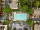 Aerial view of a community pool area with mature trees and surrounding townhomes at 4879 Seldon Se Way, Smyrna, GA 30080