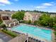 Community swimming pool with lounge chairs surrounded by trees and townhomes at 4879 Seldon Se Way, Smyrna, GA 30080