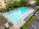 Community pool with lounge chairs, seating, and mature trees at 4879 Seldon Se Way, Smyrna, GA 30080