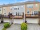 Townhome rear view featuring patios, garages, and attractive landscaping at 4879 Seldon Se Way, Smyrna, GA 30080