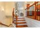 Interior view of a staircase with hardwood steps, decorative iron railings, and natural light flowing throughout at 4879 Seldon Se Way, Smyrna, GA 30080