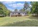 The property includes a large manicured lawn, mature trees, and a wooden deck at 5406 Jamestowne Dr, Powder Springs, GA 30127