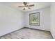 Cozy bedroom with neutral paint, modern ceiling fan and a large window at 5406 Jamestowne Dr, Powder Springs, GA 30127