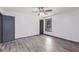 Neutral bedroom with a ceiling fan, wood-look floors and a large window at 5406 Jamestowne Dr, Powder Springs, GA 30127