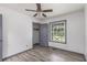 This bedroom features grey vinyl floors, a ceiling fan, and a window at 5406 Jamestowne Dr, Powder Springs, GA 30127