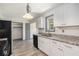 Kitchen featuring stainless steel appliances, light countertops, white cabinets, and wood look floors at 5406 Jamestowne Dr, Powder Springs, GA 30127