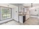 Open kitchen with white cabinets, gray countertops, stainless steel appliances, and dining area at 5406 Jamestowne Dr, Powder Springs, GA 30127