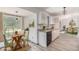 Eat-in kitchen with white cabinets, modern appliances, granite countertops and a view of the adjacent dining room at 5406 Jamestowne Dr, Powder Springs, GA 30127