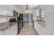 Kitchen with stainless steel appliances, light countertops, white cabinets, and wood look floors at 5406 Jamestowne Dr, Powder Springs, GA 30127