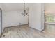 Bright living room with wood floors, modern light fixture and lots of space at 5406 Jamestowne Dr, Powder Springs, GA 30127