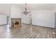 Spacious open-concept living room with fireplace, gray trim, and wood look flooring at 5406 Jamestowne Dr, Powder Springs, GA 30127