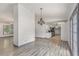 Open-concept living area with adjacent kitchen and chandelier at 5406 Jamestowne Dr, Powder Springs, GA 30127
