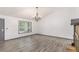 This living room features modern flooring, an elegant light fixture and natural light at 5406 Jamestowne Dr, Powder Springs, GA 30127