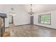 Spacious living room features modern flooring, fresh paint, and a stylish chandelier at 5406 Jamestowne Dr, Powder Springs, GA 30127